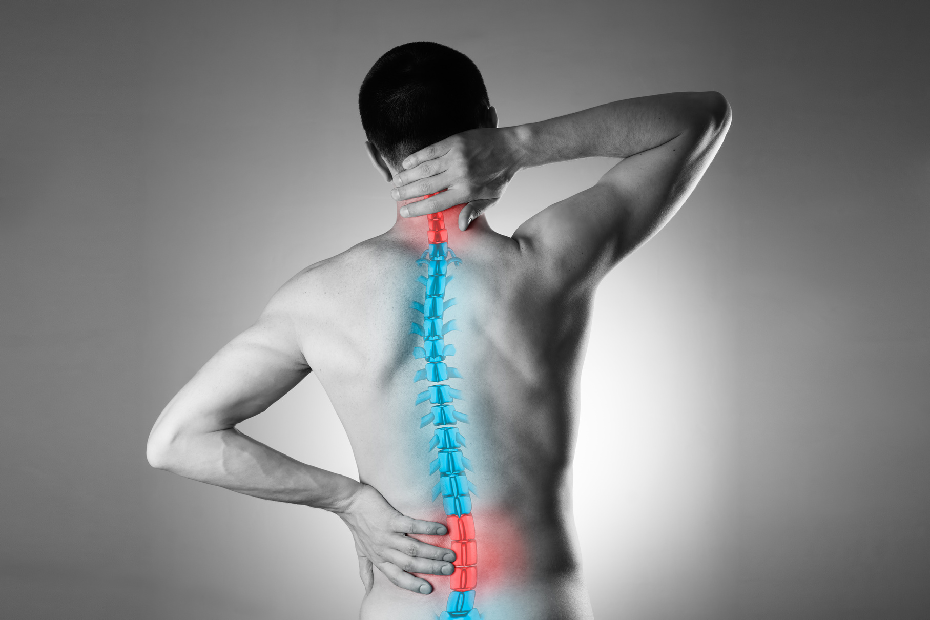 Pain in the spine, a man with backache, injury in the human back and neck
